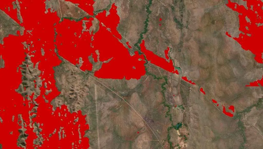 Burn scar detected by FiSci's deep learning algorithm, shown as a red overlay on satellite imagery along the Stuart Highway.
